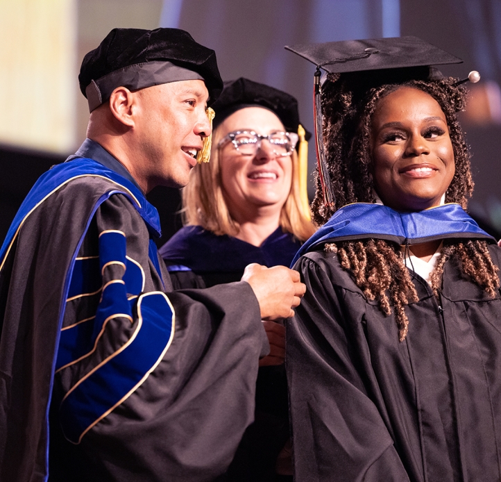 Commencement student with professors